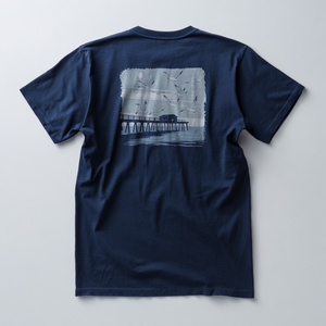 Twilight Pier illustration with seagulls flying over a pier at dusk on a Navy graphic tee.