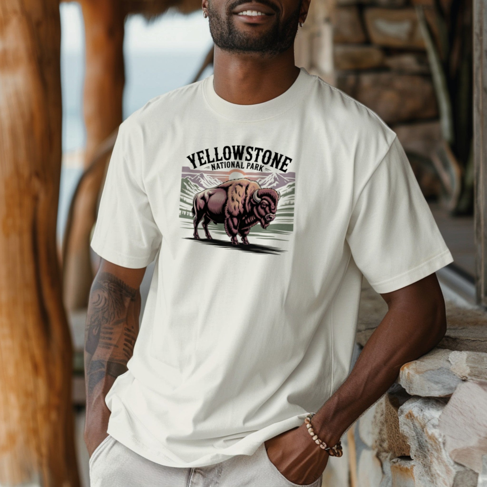 Man wearing a white t-shirt with Yellowstone National Park graphic, standing outdoors.