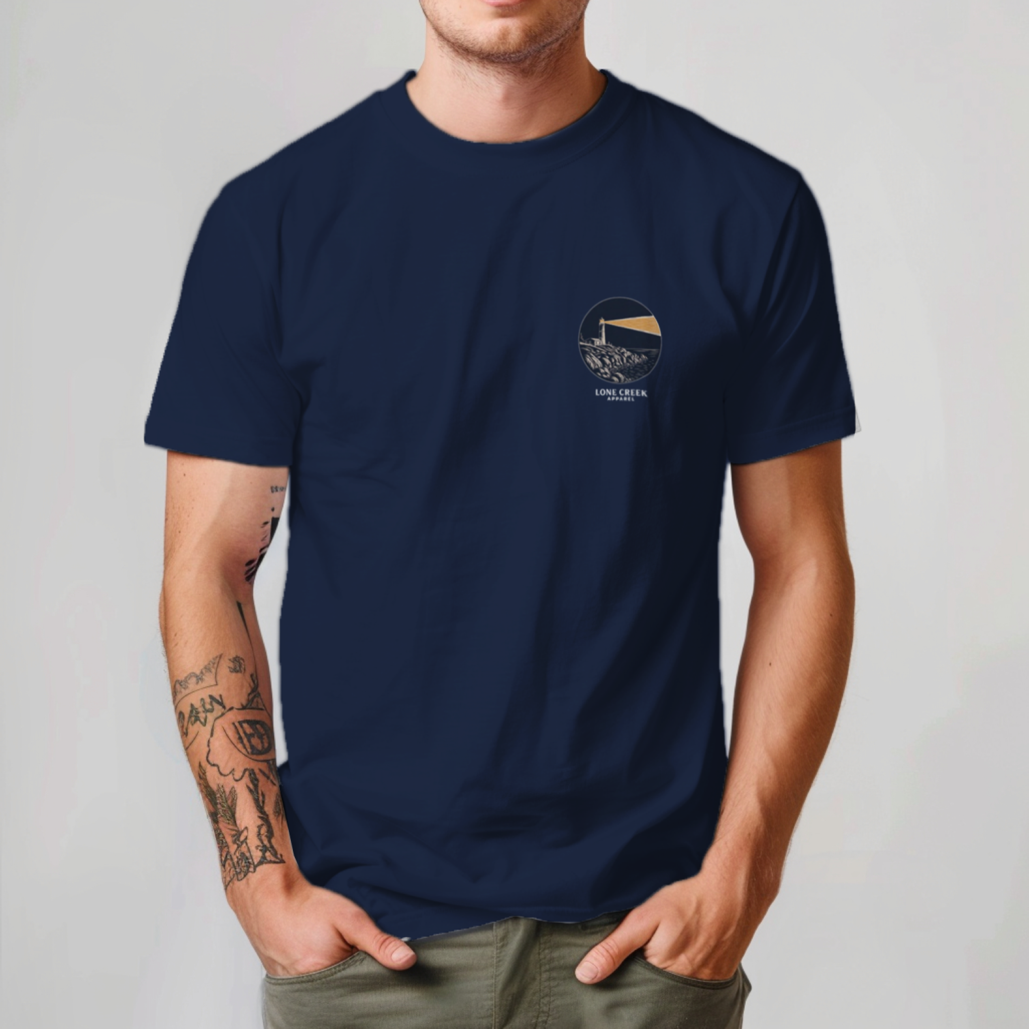 Person wearing a navy blue t-shirt with a logo on a plain background