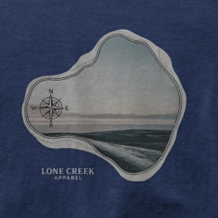 Navy blue t-shirt with a graphic of an island and compass, featuring 'Lone Creek Apparel' text.