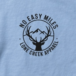 Light blue t-shirt with black 'No Easy Miles' logo featuring a deer and mountains on a light blue background.