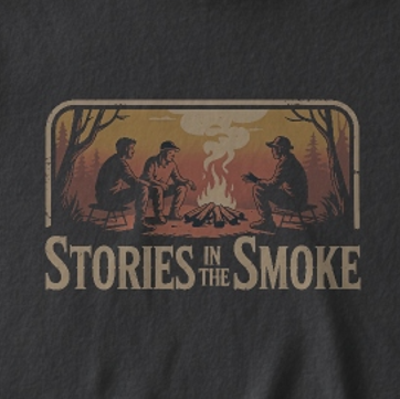 T-shirt with a graphic of three people around a campfire and 'Stories in the Smoke' text on a dark background.