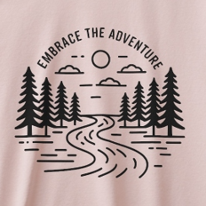 T-shirt with 'Embrace the Adventure' graphic on a light pink background