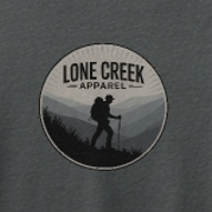 circular logo of a hiker on a hill on the chest against a charcoal background