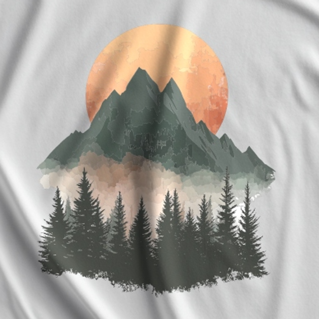 T-shirt with a graphic of mountains and trees under a sunset on a white background