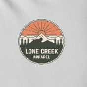 Detail of mountain peaks and sun rays in a circular badge on a White cotton tee