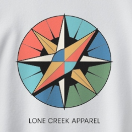Multi-colored geometric compass rose logo on a White midweight fleece crewneck sweatshirt.