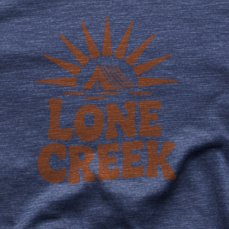 Burnt orange retro sunburst and tent logo with Lone Creek text on a heather midnight navy tee.