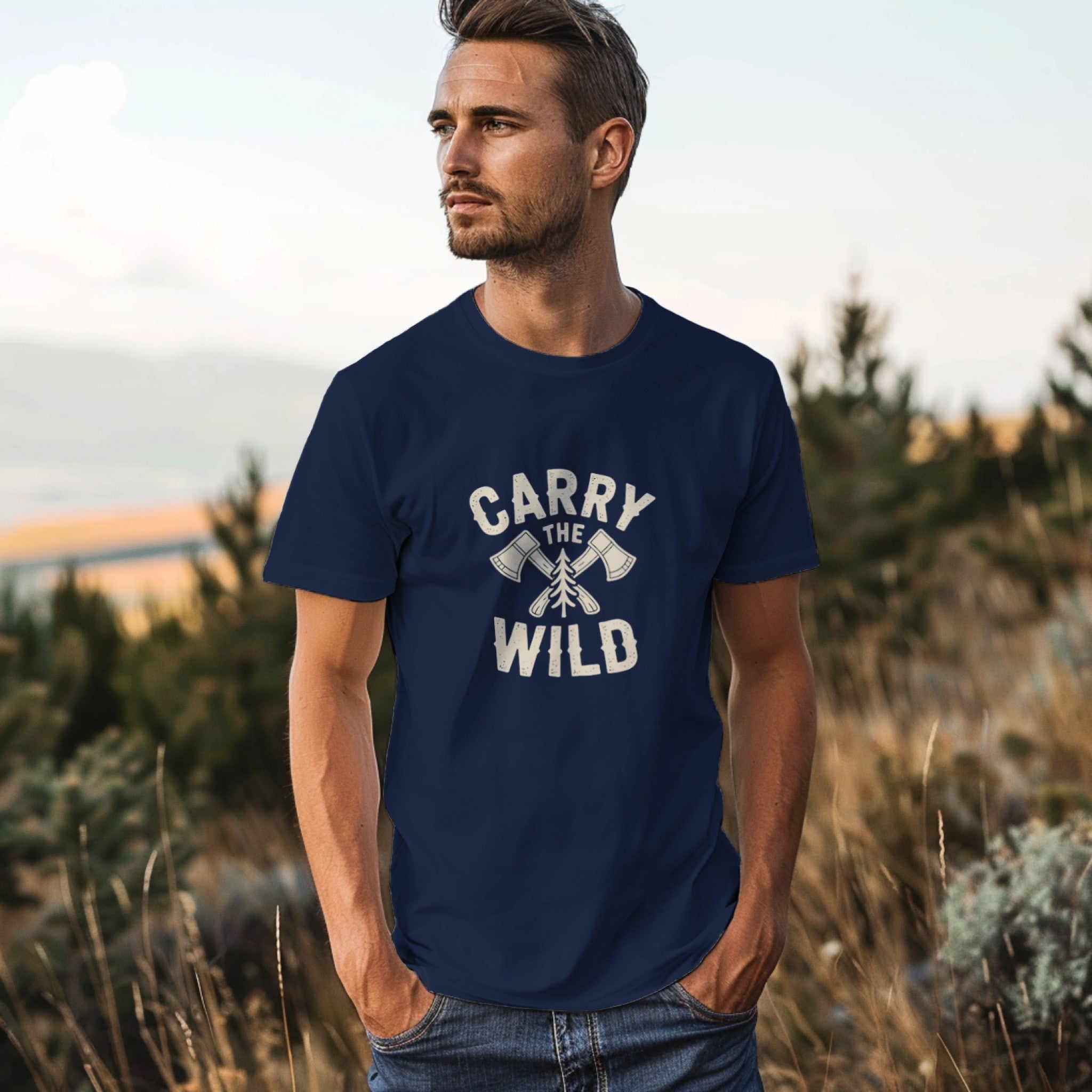 Man wearing a navy blue t-shirt with 'Carry the Wild' text in a natural setting
