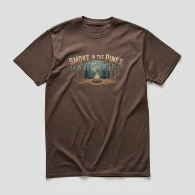 Multicolour campfire and pine forest graphic with Smoke in the Pines text on a Brown graphic tee