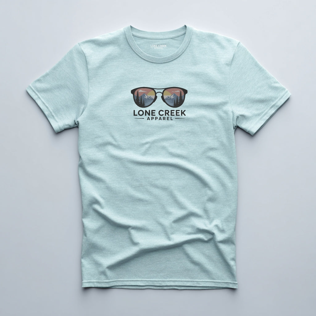 Mountain sunglasses graphic with sunset scene on a Heather Mint lightweight cotton tee.