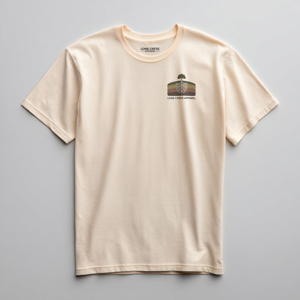 Retro tree and root cross-section graphic on a Soft Cream lightweight cotton tee.