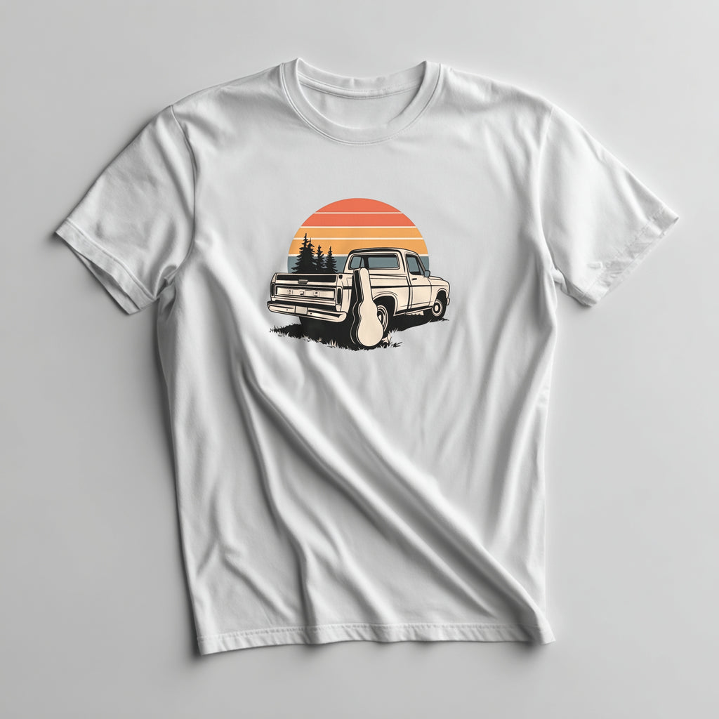White t-shirt with a graphic of a vintage truck and sunset design on a gray background