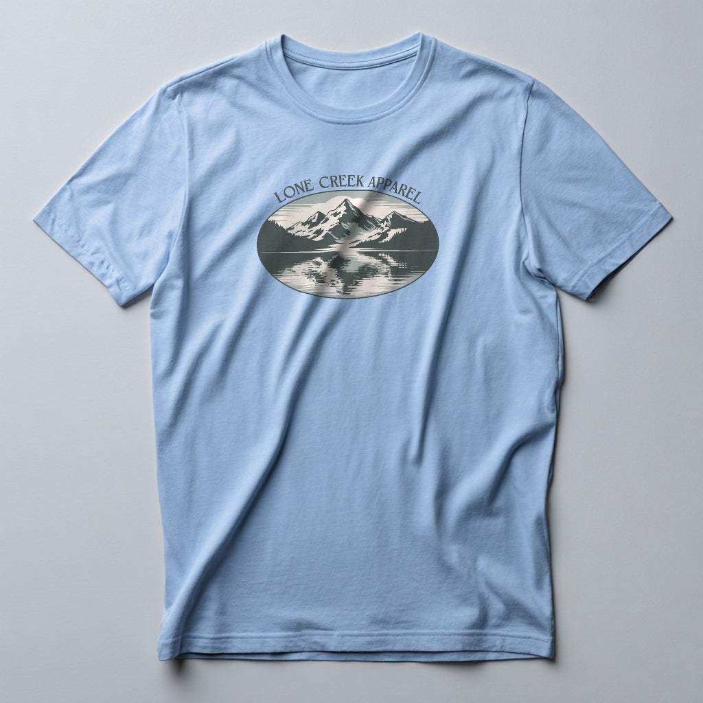 Light blue t-shirt with mountain graphic and 'Lone Creek Apparel' text on a gray background