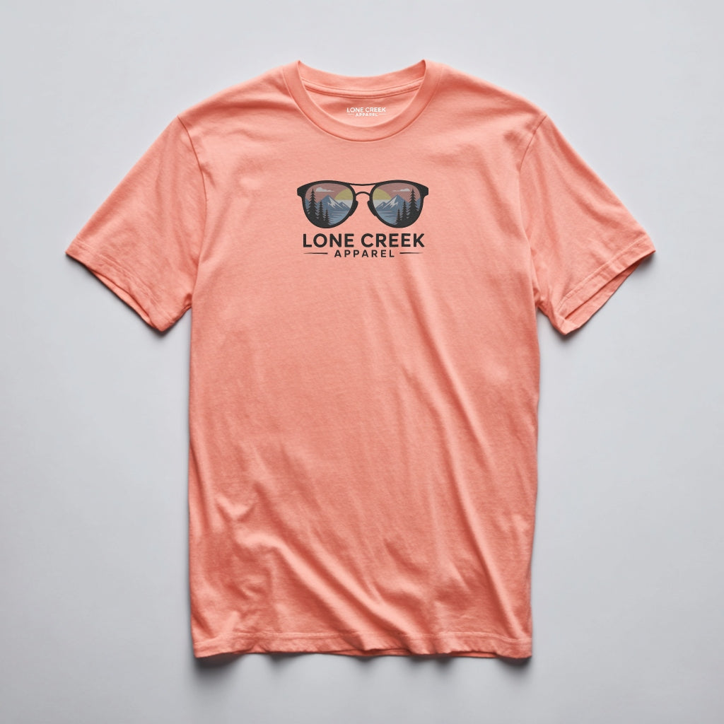 Mountain sunglasses graphic with sunset scene on a Coral lightweight cotton tee.