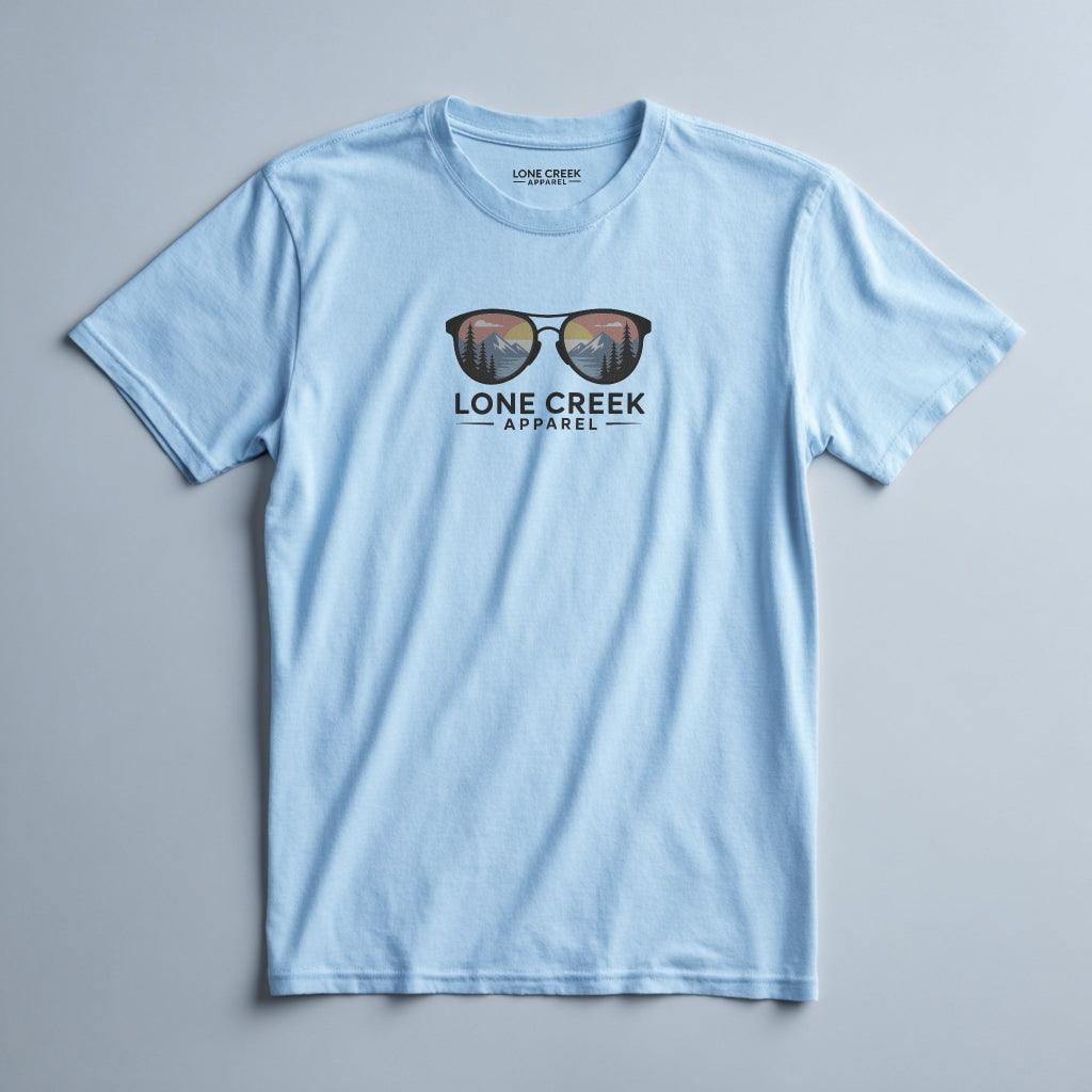 Mountain sunglasses graphic with sunset scene on a Baby Blue lightweight cotton tee.