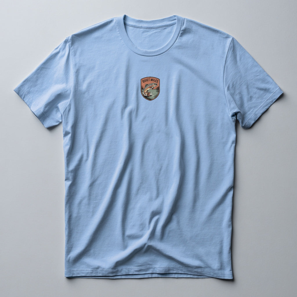 Light blue t-shirt with a small logo on the chest against a gray background