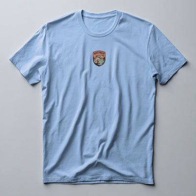Light Blue graphic tee with a multicolour trout shield badge on the left chest