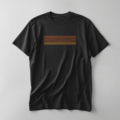 Retro striped mountain graphic in rust-red, orange, and gold on a Vintage Black graphic tee