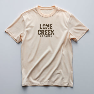 Typographic mountain emblem print on a Cream lightweight cotton tee