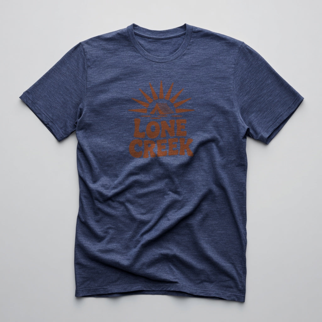 Burnt orange retro sunburst and tent logo with Lone Creek text on a heather midnight navy tee.