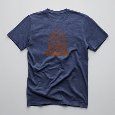 Burnt orange retro sunburst and tent graphic with Lone Creek text on a Heather Midnight Navy graphic tee